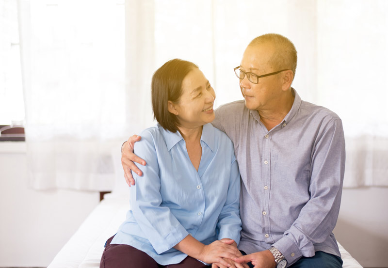 Older asian couple talking about life insurance